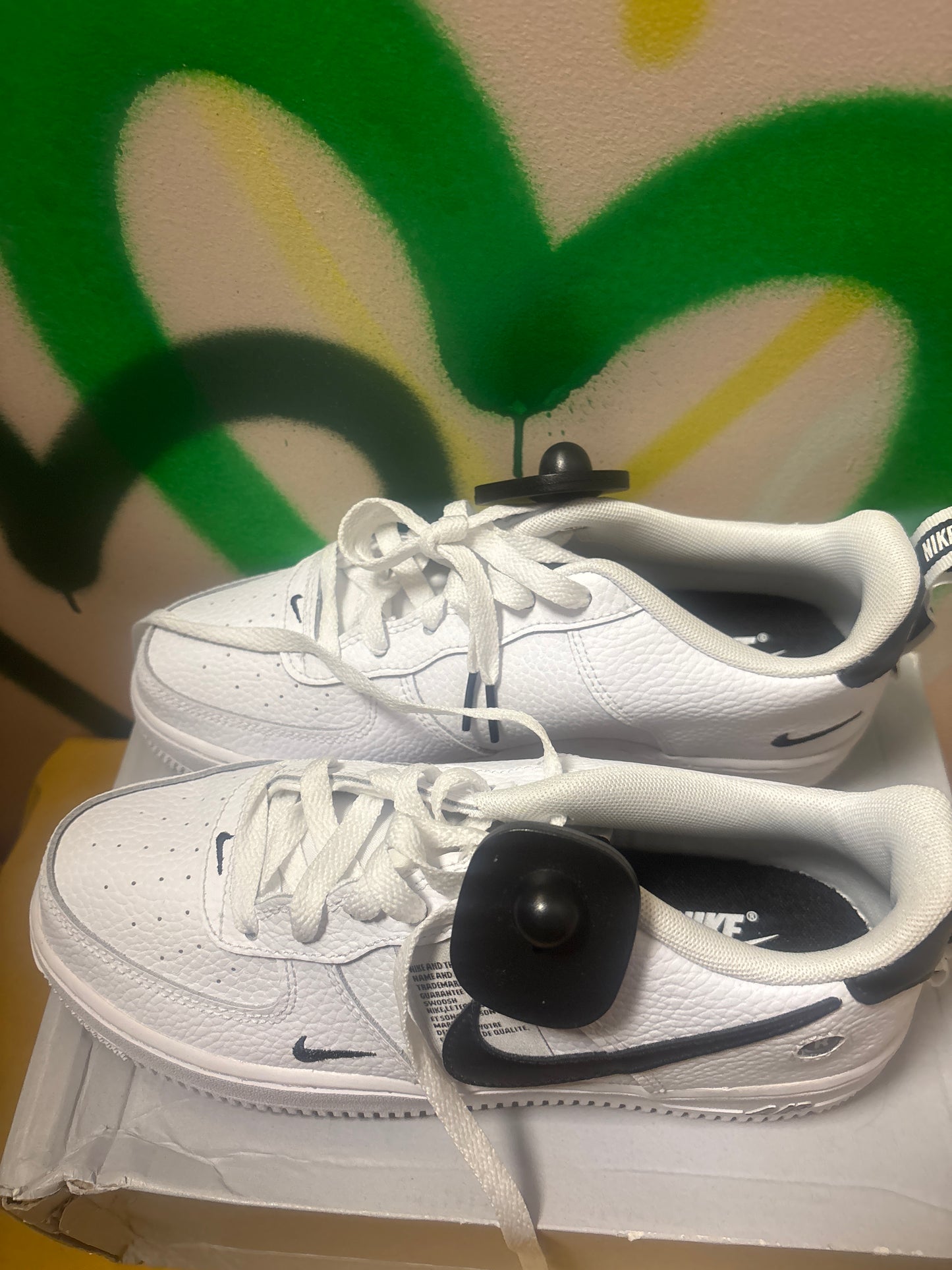 white Nike Air Force 1 LV8 Utility sneakers feature black swooshes and branding accents Size 6 Youth