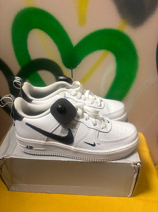 white Nike Air Force 1 LV8 Utility sneakers feature black swooshes and branding accents Size 6 Youth
