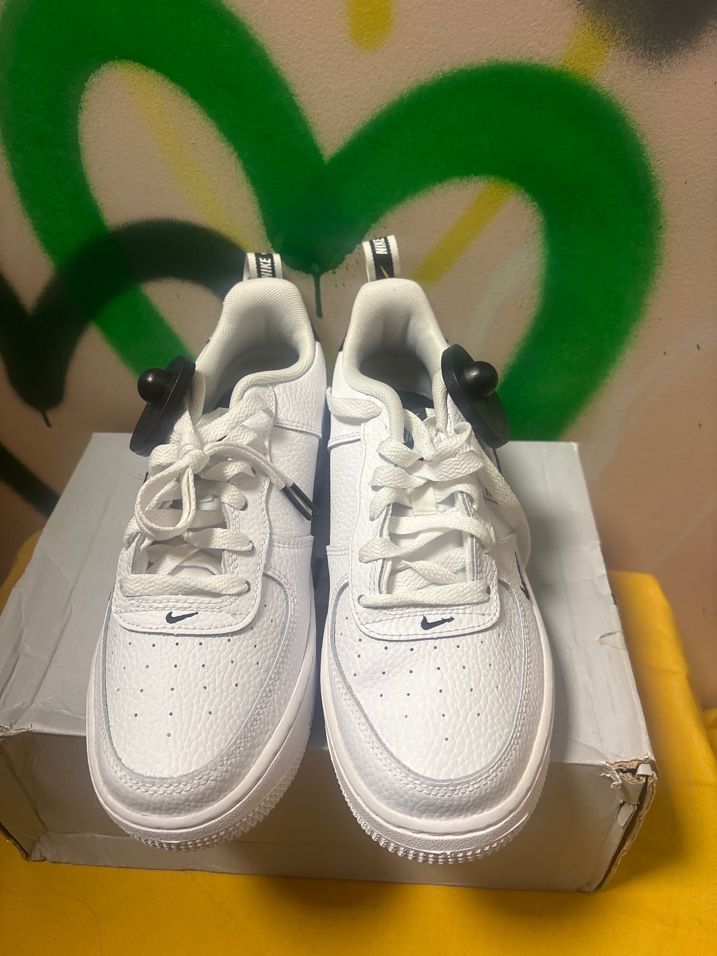 white Nike Air Force 1 LV8 Utility sneakers feature black swooshes and branding accents Size 6 Youth