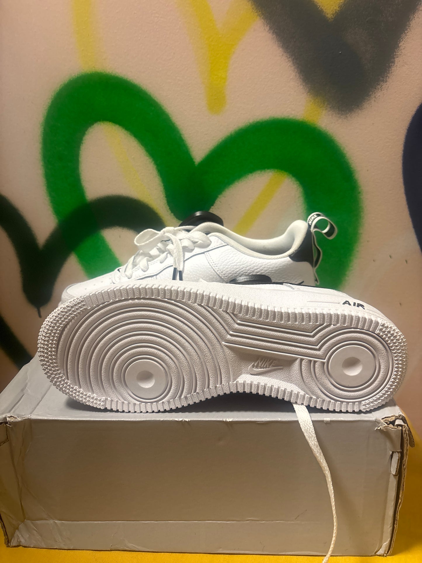 white Nike Air Force 1 LV8 Utility sneakers feature black swooshes and branding accents Size 6 Youth